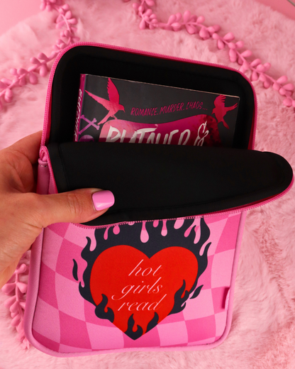 Pink checkered e-reader sleeve with zip, hand holding front pouch with tablet inside