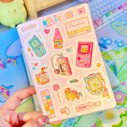 90s Kid sticker sheet angled with retro console, pink gadgets, hearts, and chat boxes