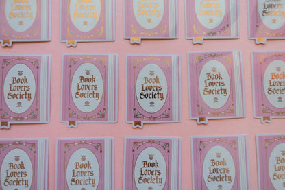 Vinyl sticker cards displayed in multiple rows, each with oval “Book Lovers Society” logo