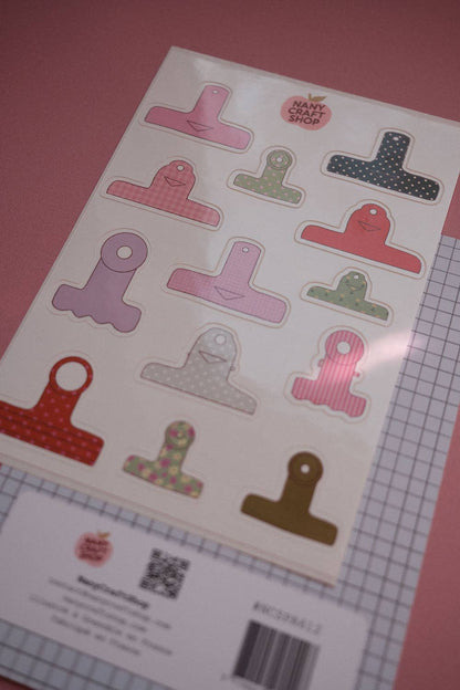 Board clamps sticker sheet with colorful clamp pieces and product label at bottom