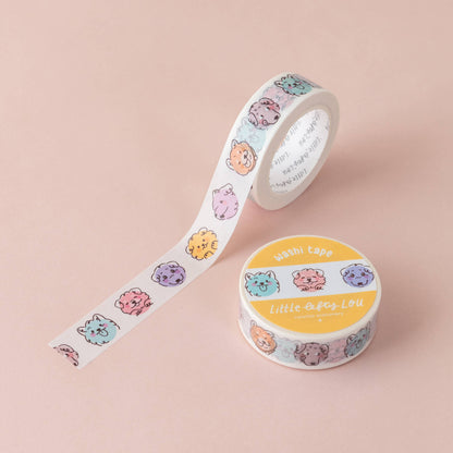 Washi tape roll with colorful dog-face strip beside matching roll