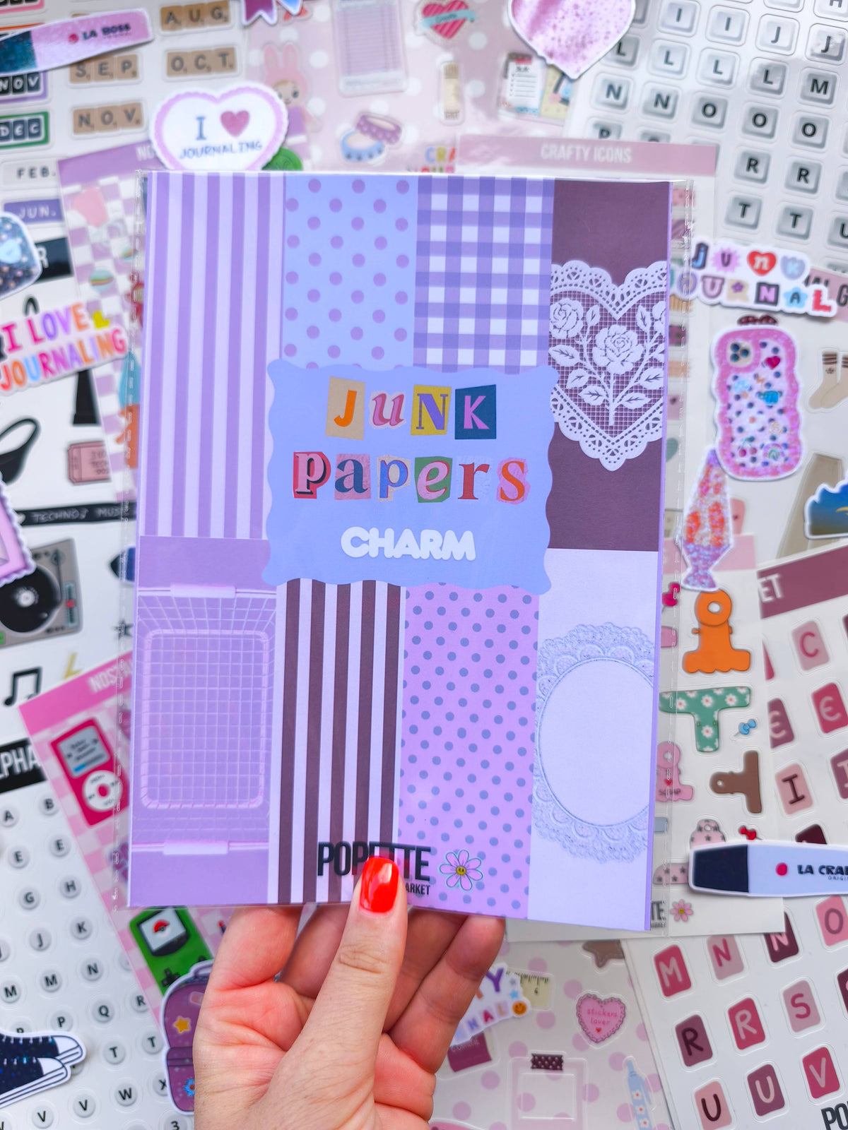 Junk papers charm paper pack held up showing purple stripes, polka dots, and lace heart panel