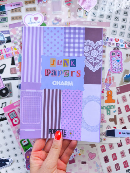 Junk papers charm paper pack held up showing purple stripes, polka dots, and lace heart panel