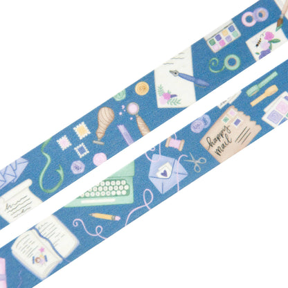 Blue washi tape roll strip showing stationery motifs like envelopes, pens, and hearts.