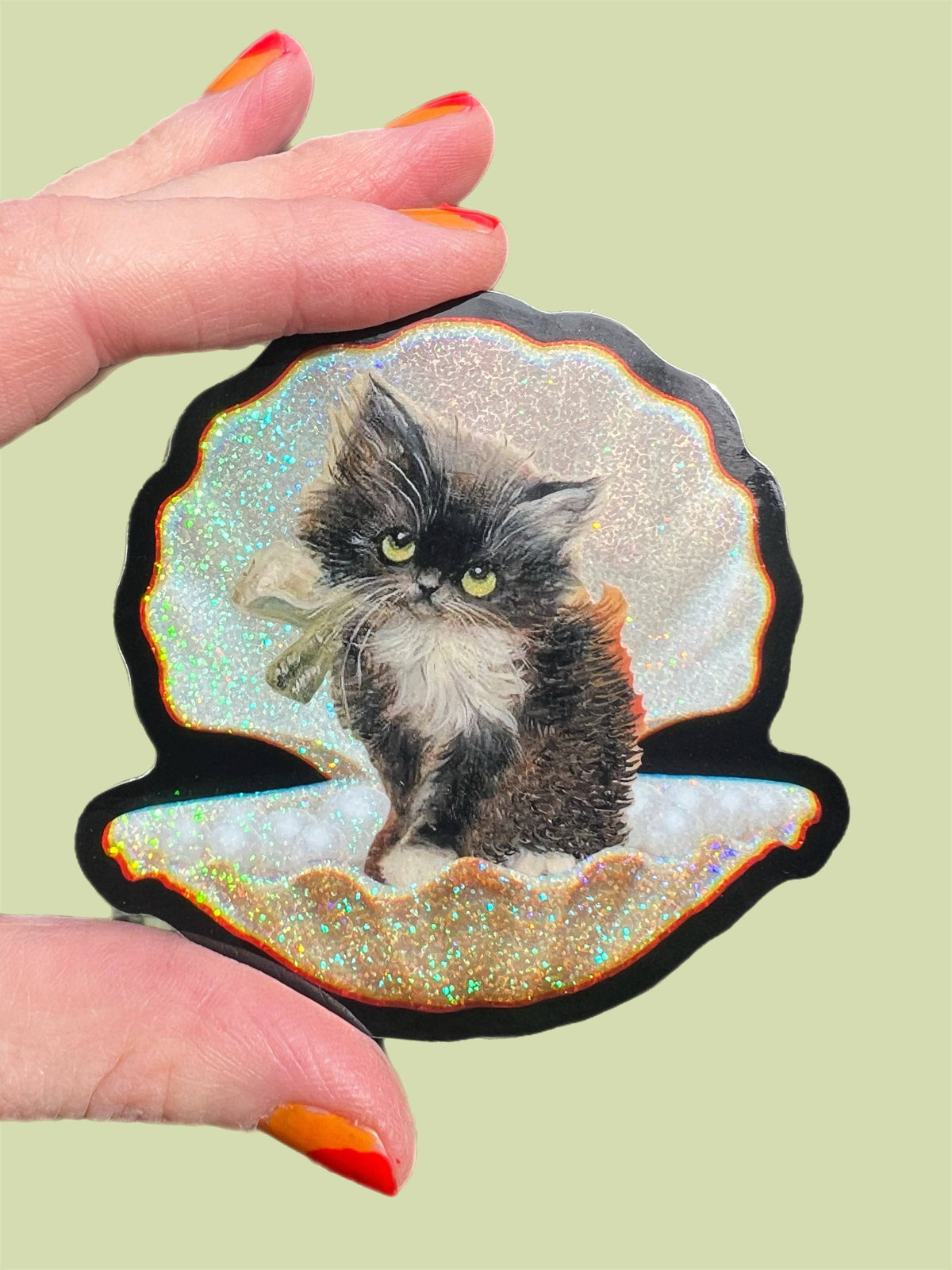 3-inch tuxedo cat in seashell sticker with glittery iridescent edges