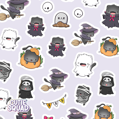 Close-up of spooky cat sticker sheet featuring witch, ghost, and gravestone designs