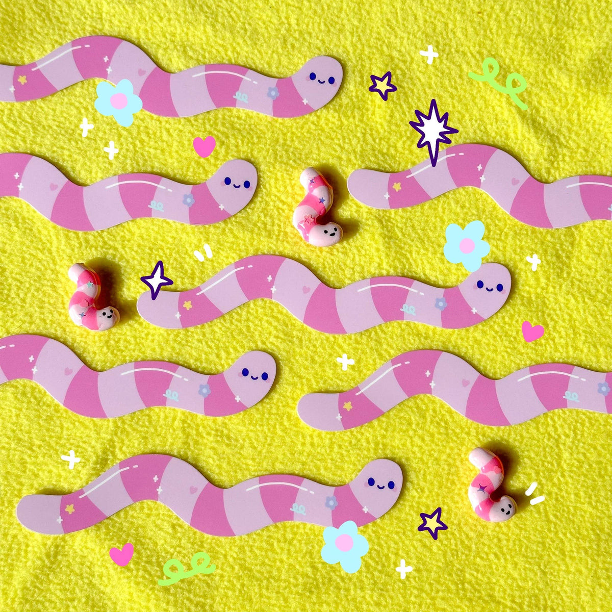 Long Wormie sticker sheet with purple-pink smiling worm characters and stars