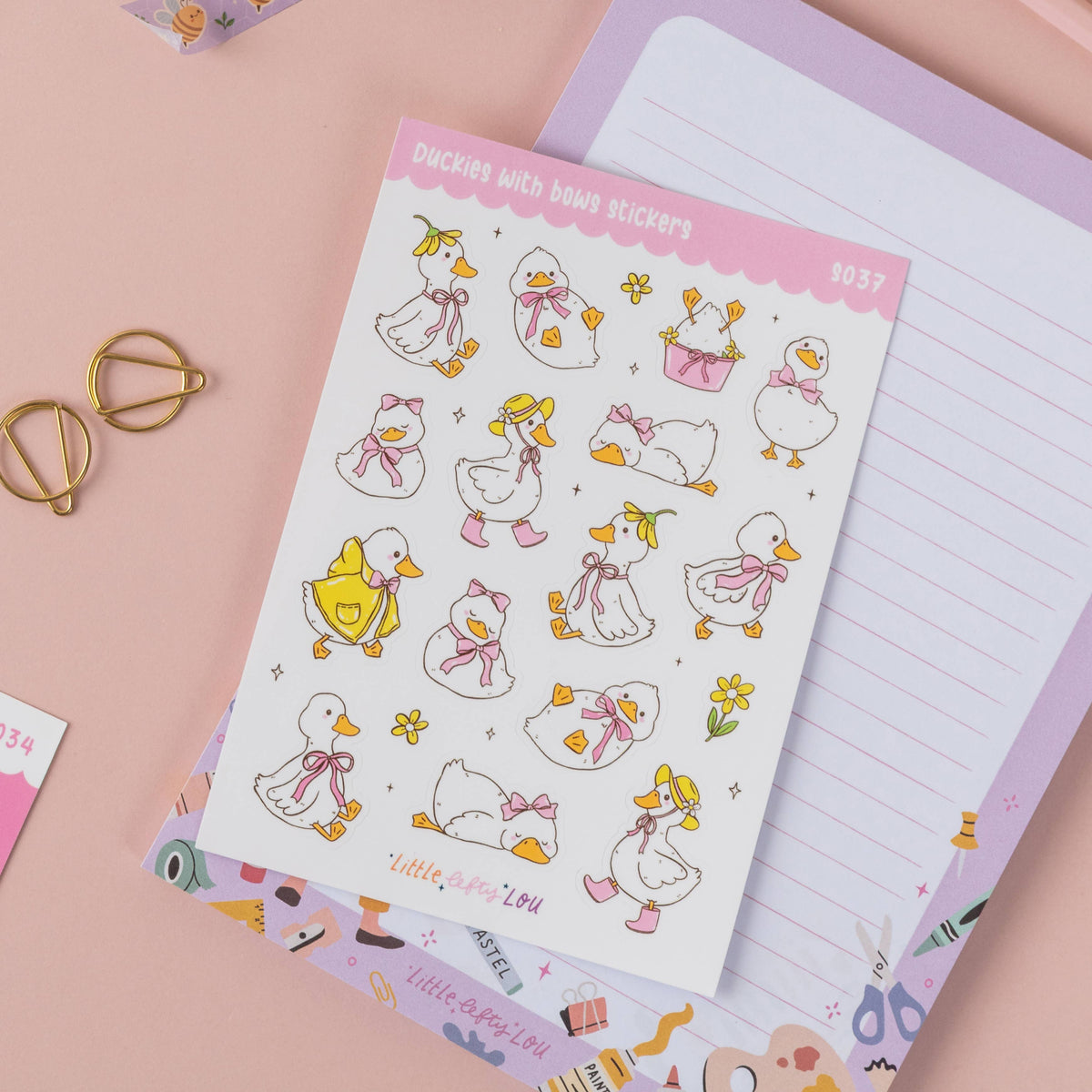 Duck sticker sheet with bows, flowers, and ribbon accents on a page