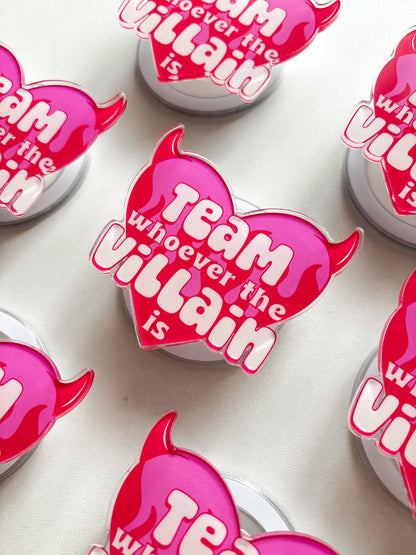 Pink devil heart magnetic grip with 'Team whoever the villain is' text, angled