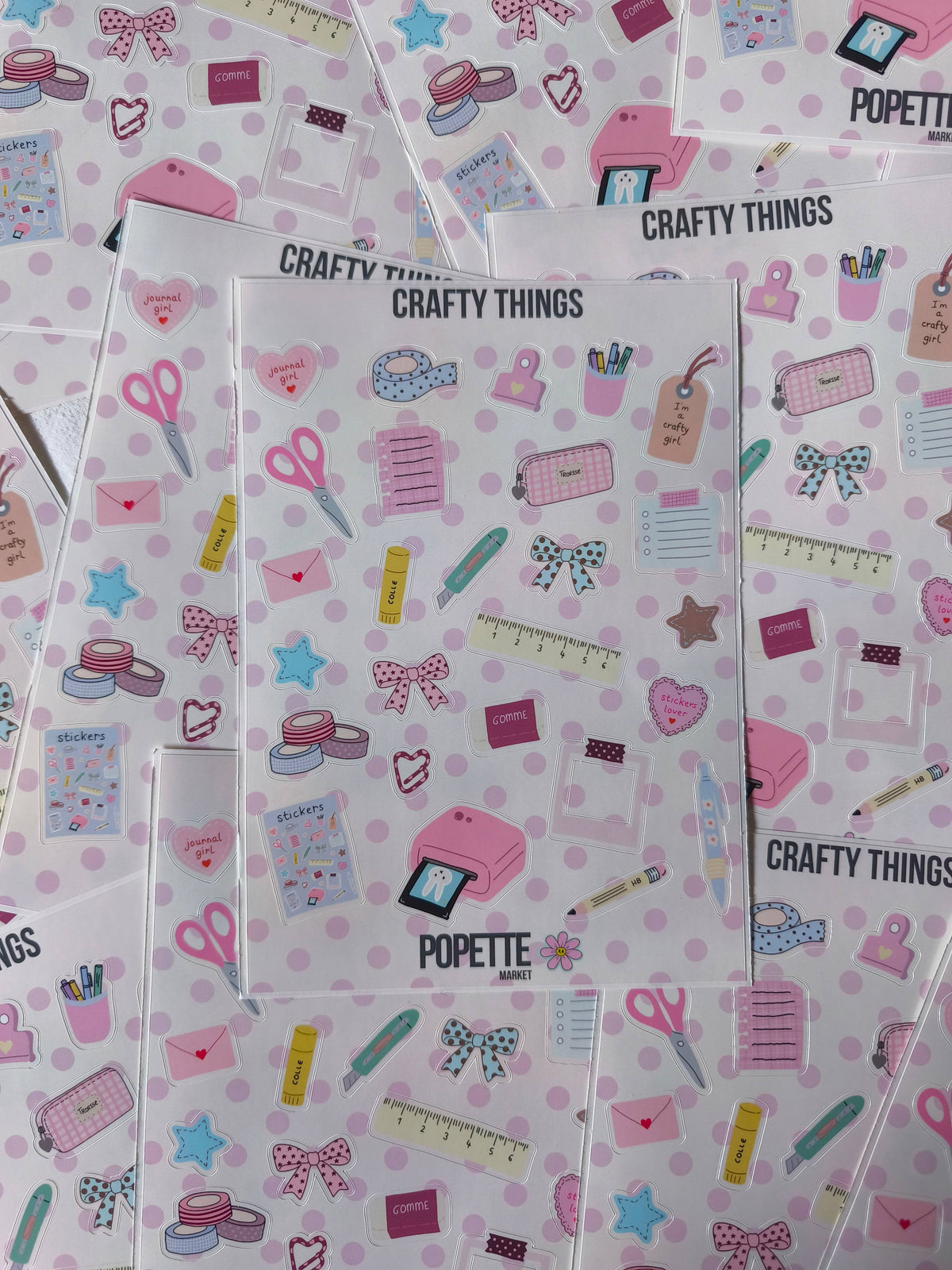 Set of A5 sticker sheets overlapping, pastel craft icons on white with pink dots