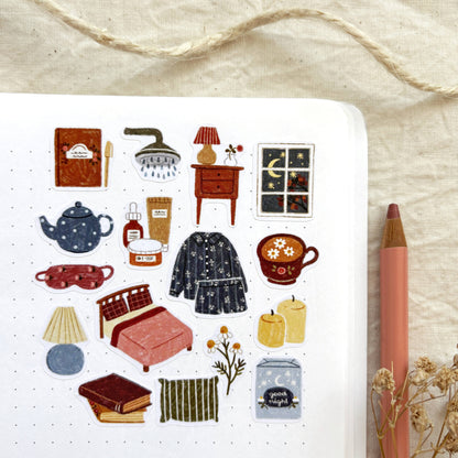 Bedtime sticker sheet close-up with teapot, pajama set, chair, and window icons