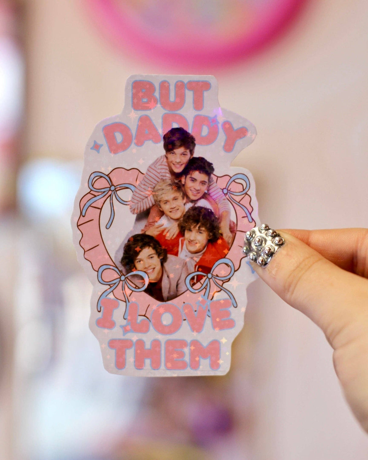 One Direction But Daddy I Love Them sticker close-up, iridescent pink-purple bow heart photo