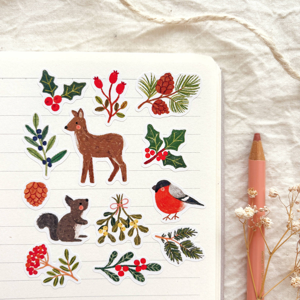 Winter nature sticker sheet with deer, robin, squirrel, holly, pinecones, and berries