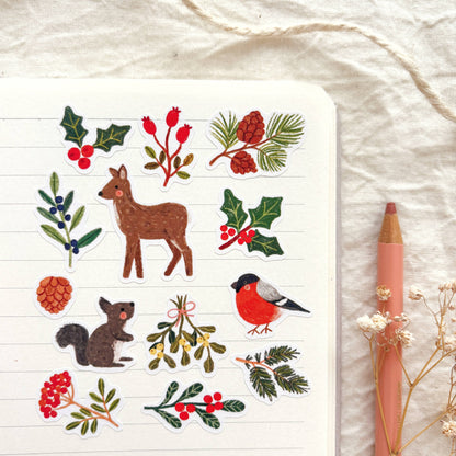 Winter nature sticker sheet with deer, robin, squirrel, holly, pinecones, and berries