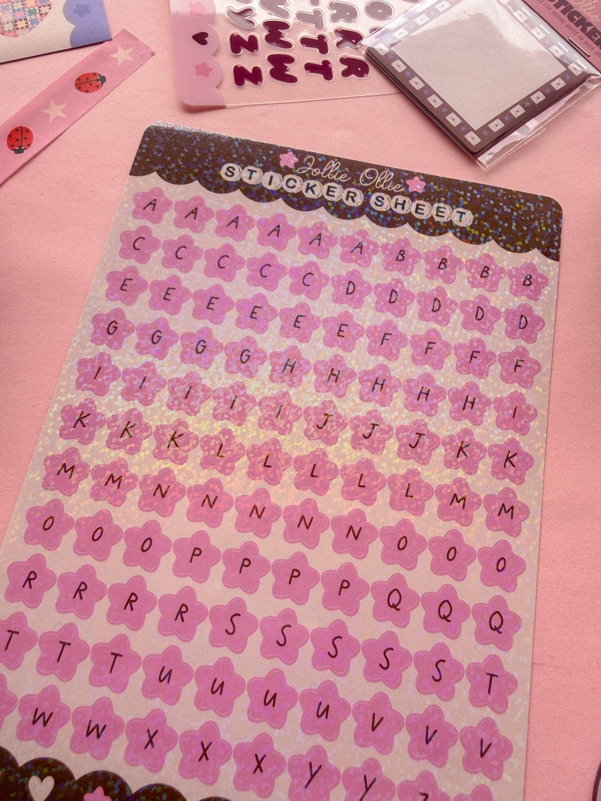 Pink alphabet sticker sheet with sparkly letters in a grid layout