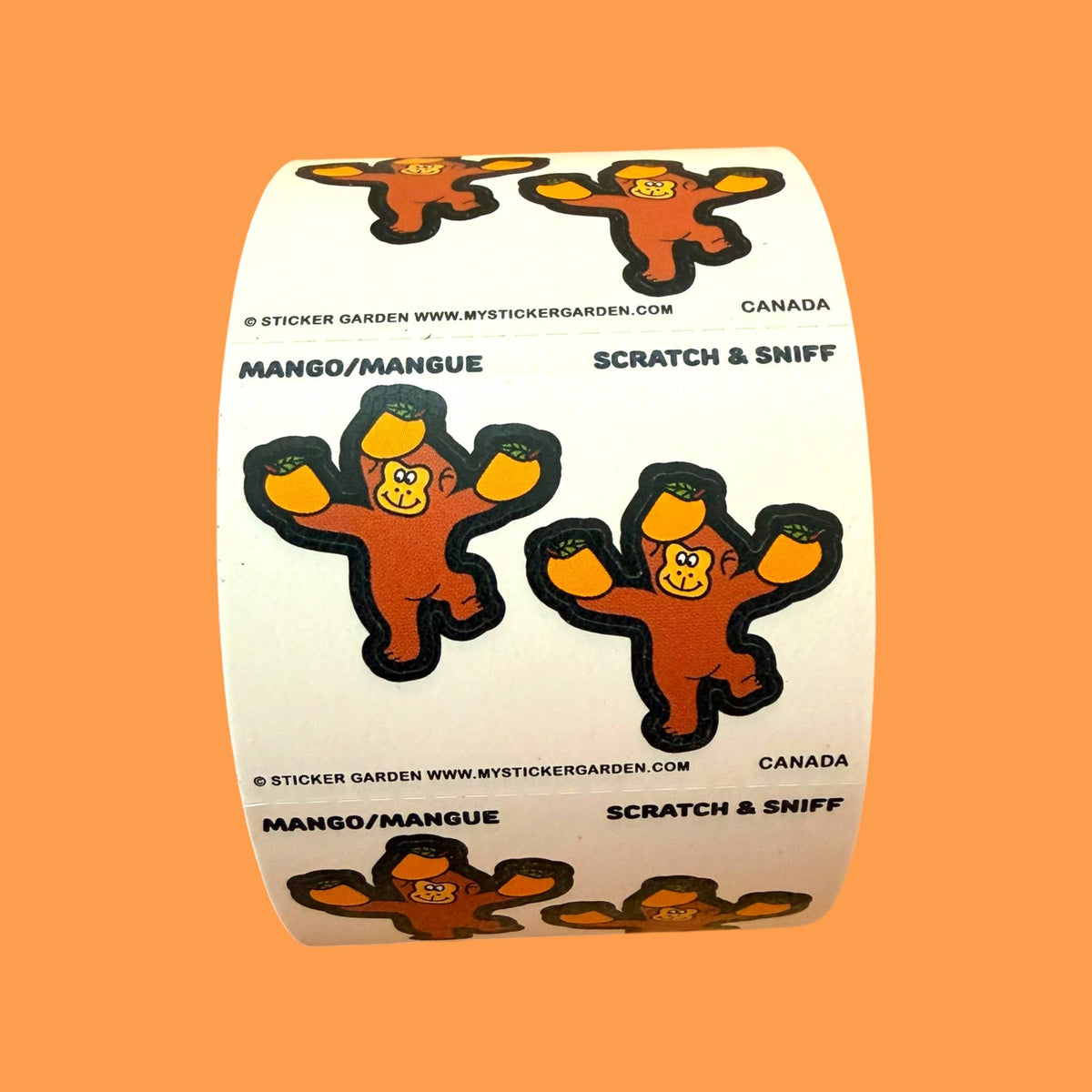 Scratch-and-sniff sticker roll packaging with mango-orange monkey icons and Canada text
