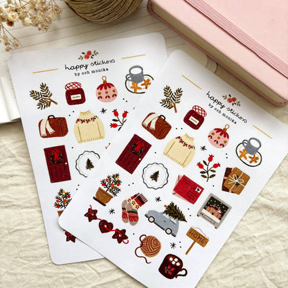 Winter sticker sheets with coffee mugs, gift boxes, ornaments, and a small home sign.