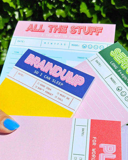 Overlapping A6 notepads with bold 'Brain dump' and 'All the stuff' headings