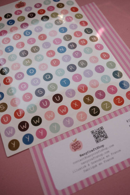 Alphabet letter sticker sheet with multicolor circular letters and product label