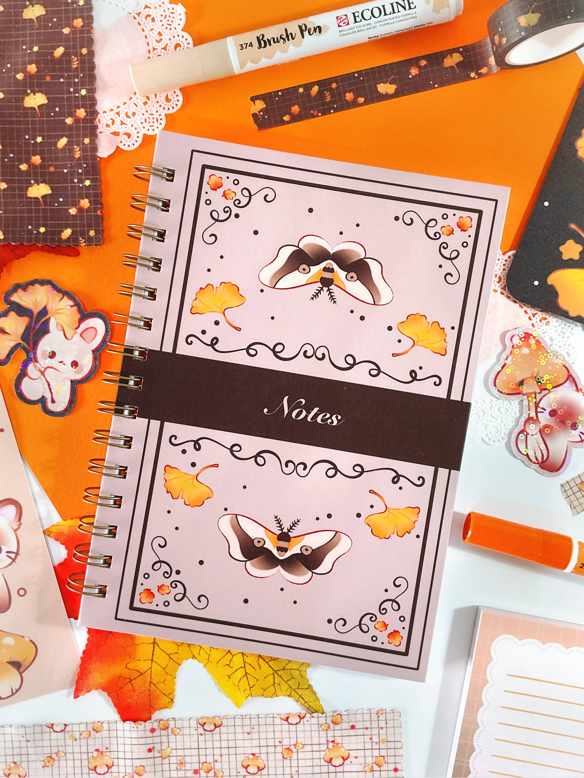 Spiral notebook with orange cover, animal illustrations, and “Notes” panel