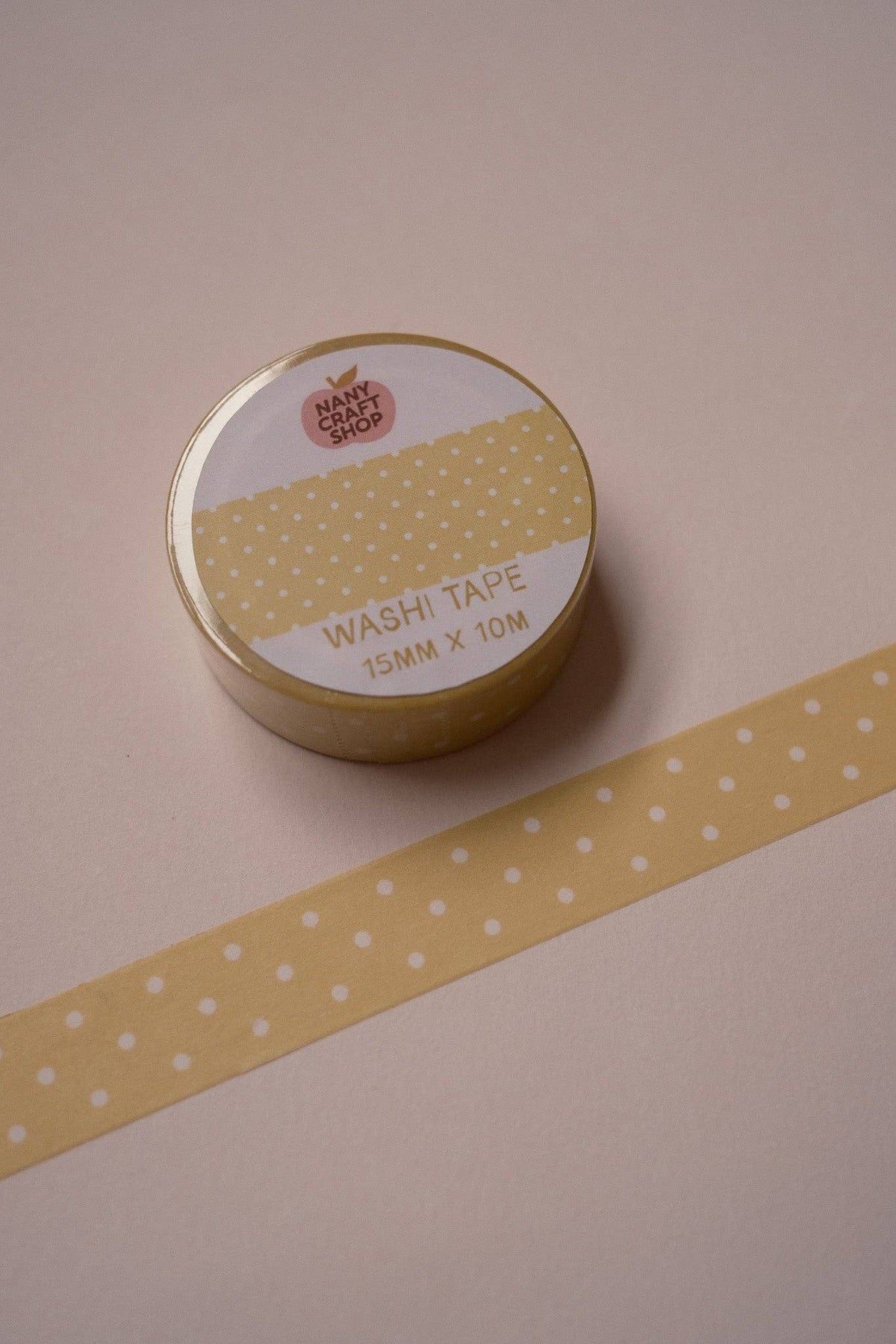 Yellow polka dot washi tape roll with long polka dot tape strip
