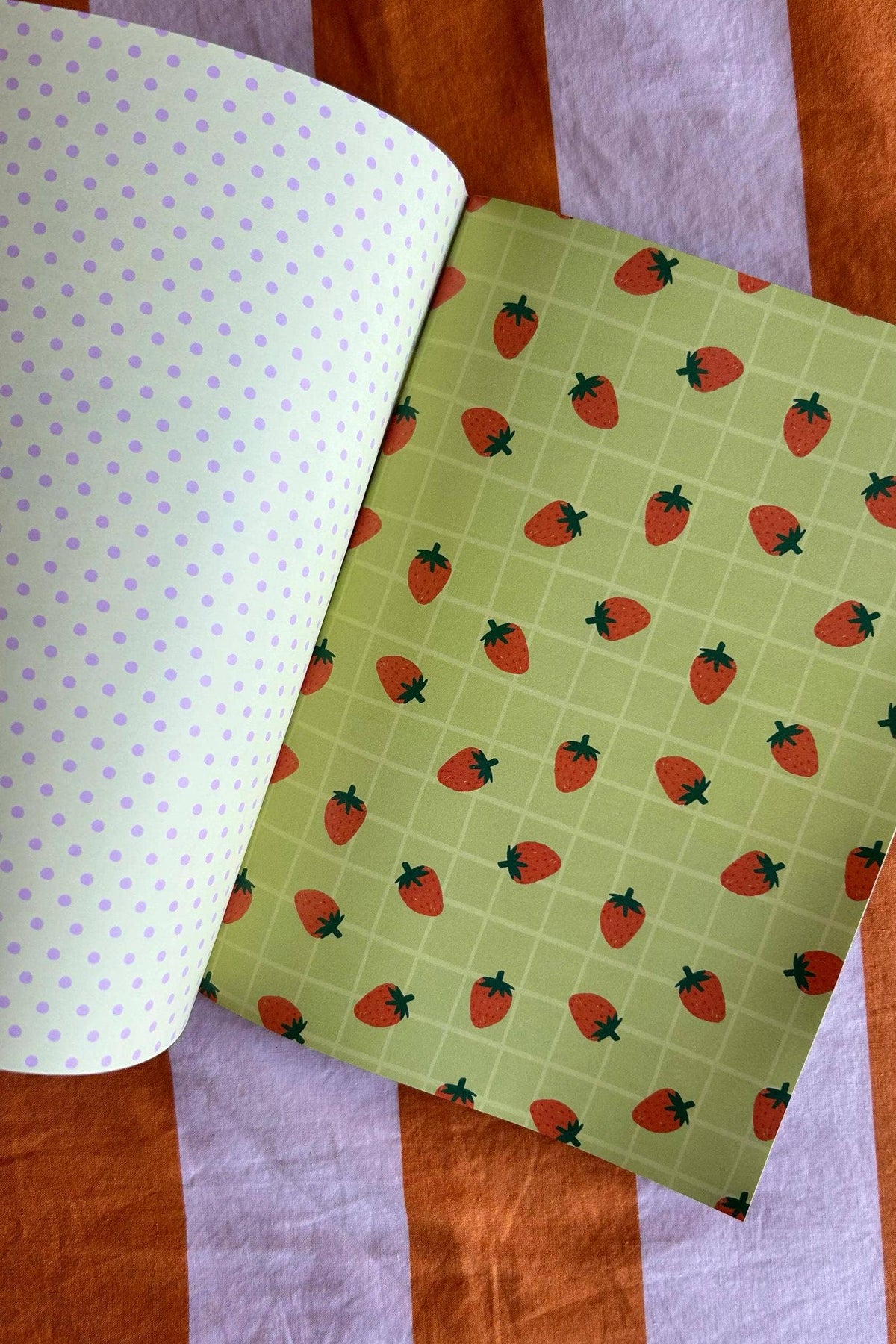 A5 scrapbook paper sheet with green strawberry grid and light purple polka dots