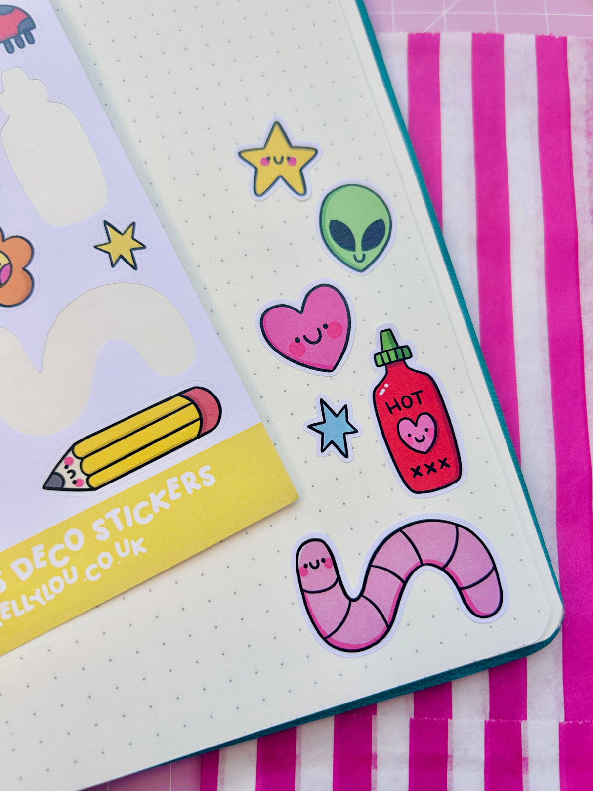 Deco sticker sheet corner with cartoon stickers: alien face, heart, hot cup, pencil, star