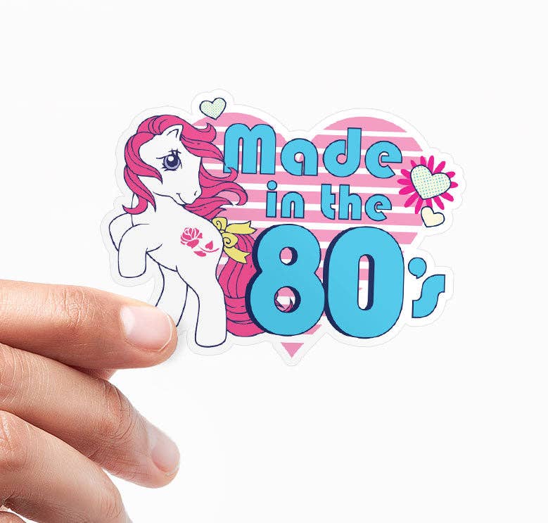 Vinyl sticker with pastel unicorn holding baby, text 'Made in the 80's' on heart