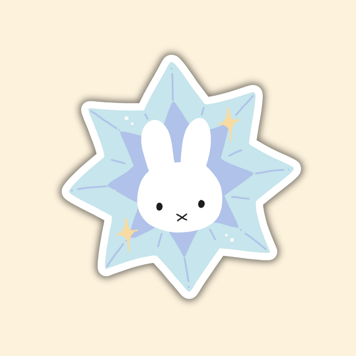 Star-shaped bunny sticker in light blue with white bunny face and small gold accents