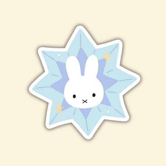 Star-shaped bunny sticker in light blue with white bunny face and small gold accents