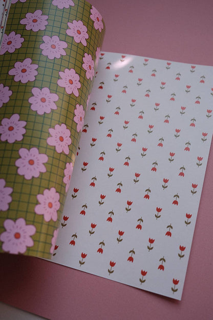 Open scrapbook papers: green grid with pink flowers on left, red tulips pattern on right