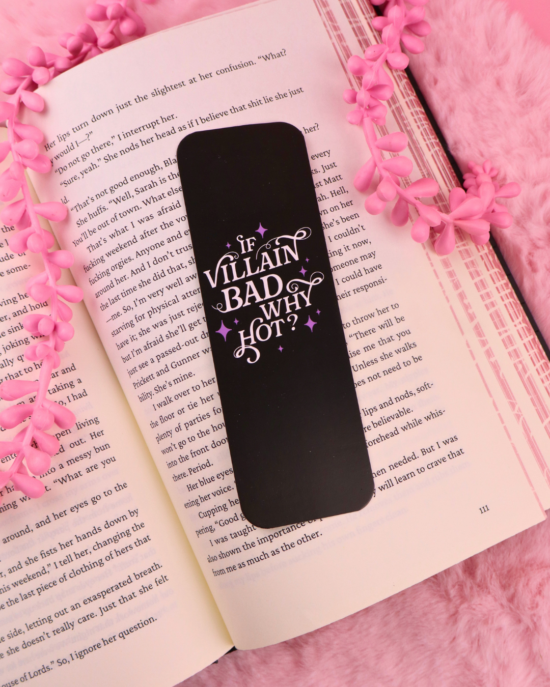 Black bookmark with purple "If Villain Bad Why Hot?" lettering on open pages