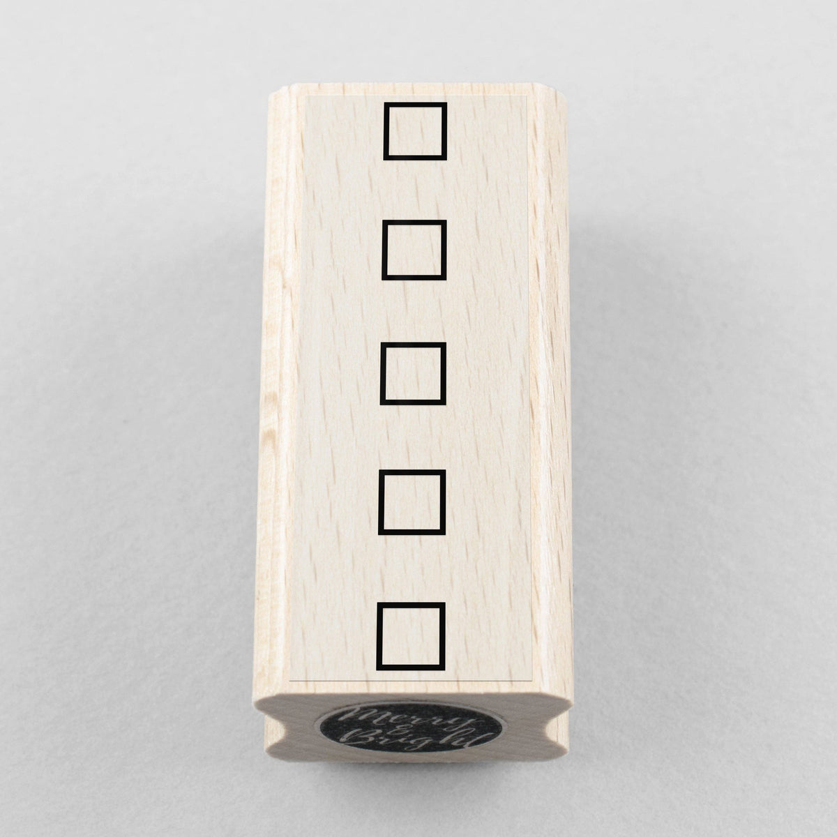 Wooden stamp block with four stacked square checkbox outlines