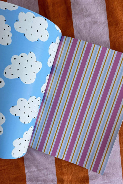 A5 scrapbook paper sheet with light blue clouds pattern and pastel striped design