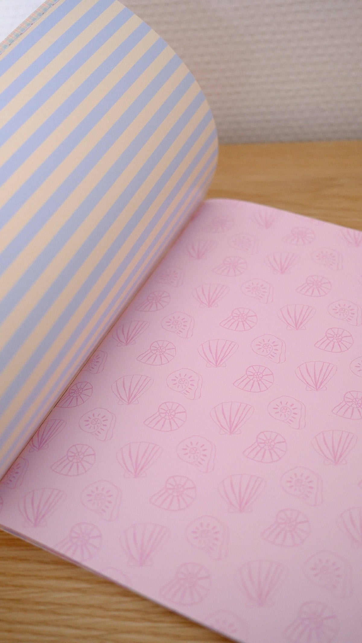 Scrapbook paper set with pale blue striped sheet and pink seashell fan sheet
