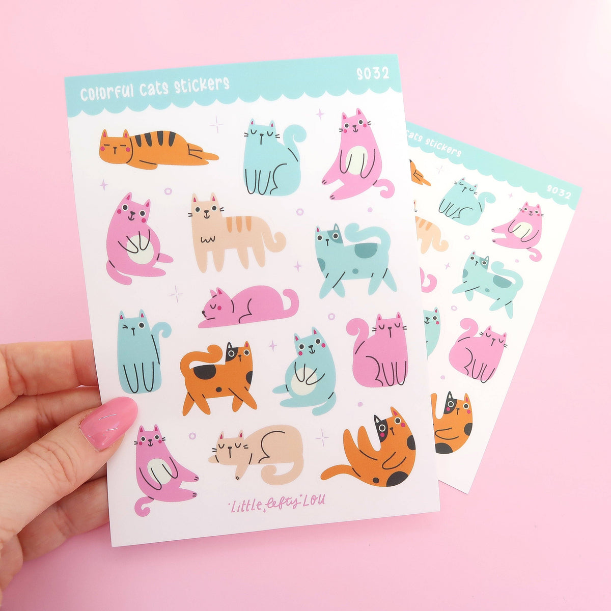 Waterproof cat sticker set: two sheets of colorful cats, held in hand