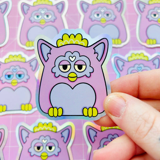 Holographic Furby cat sticker, purple outline with heart nose and yellow eyes