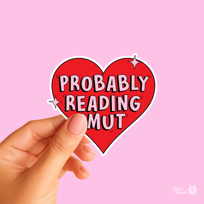 Heart-shaped sticker held by hand, red text 'PROBABLY READING MUT'.