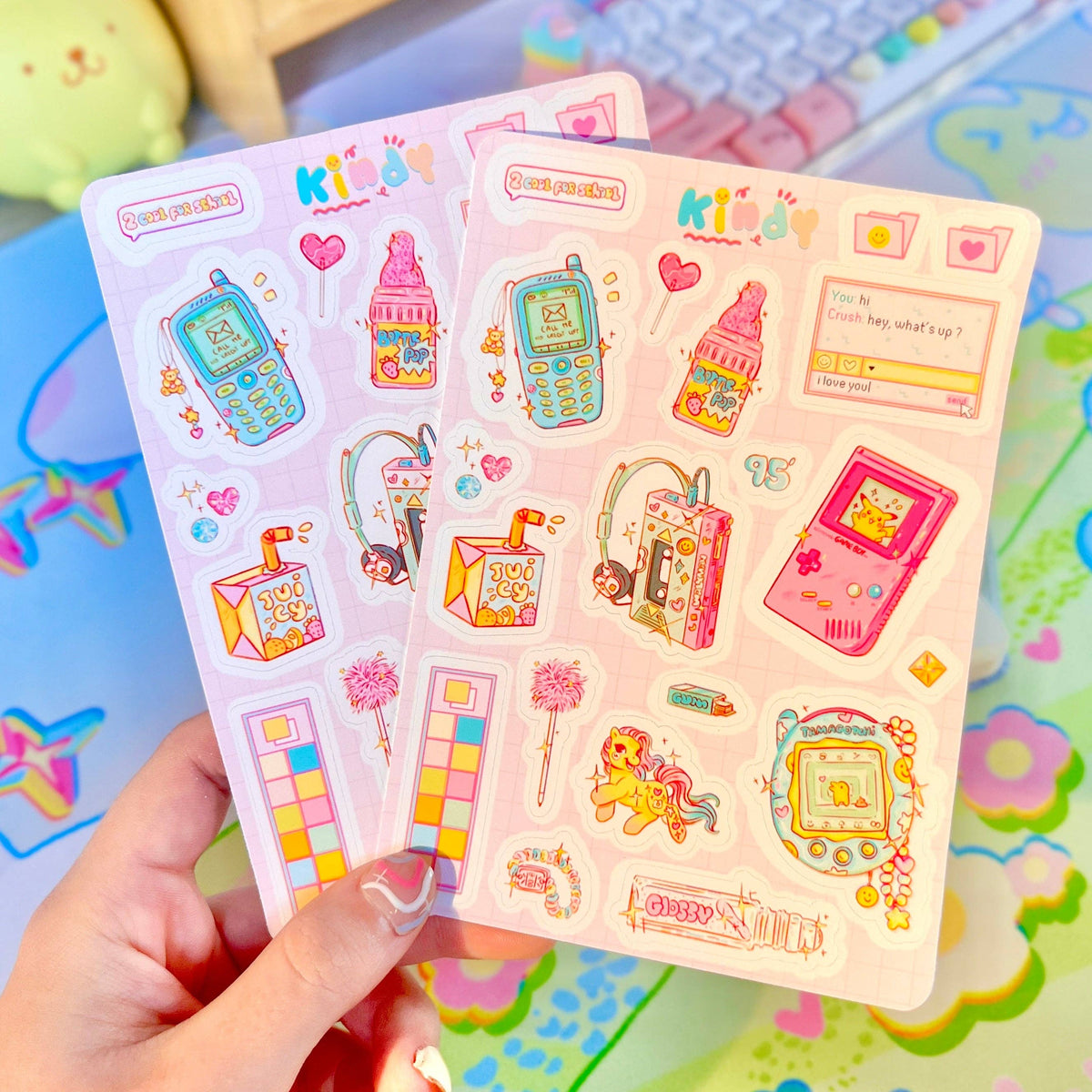 90s Kid sticker sheet pair in hand with pink and blue retro device stickers