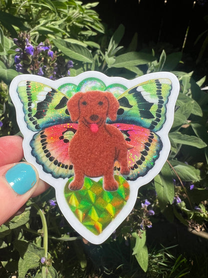 Butterfly dachshund sticker with orange dog and iridescent green, yellow, and pink wings
