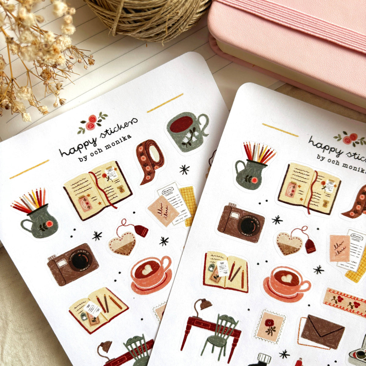 Two sticker sheets with coffee, books, camera, utensils and heart icons