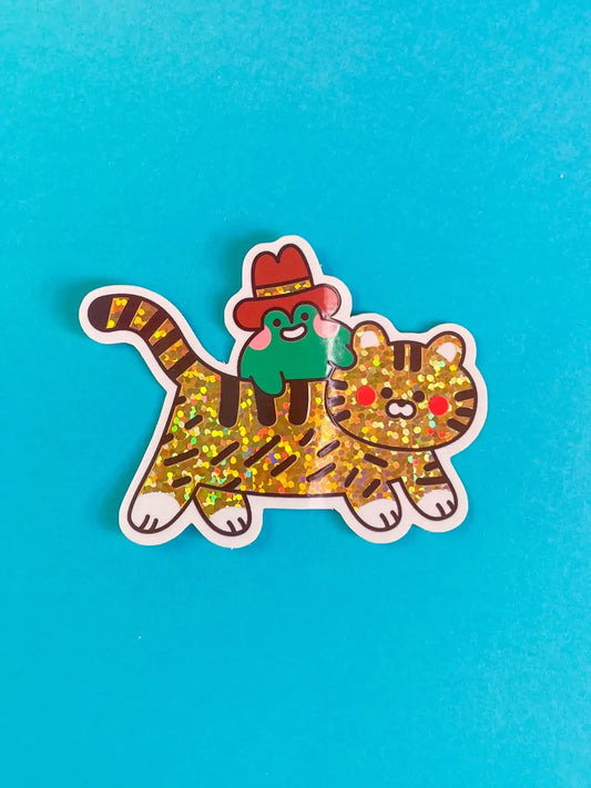 Vinyl tiger sticker with green cap and red collar, gold speckled pattern, white outline
