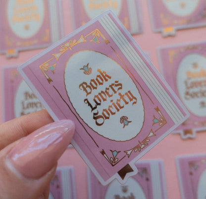 Vinyl sticker with purple border and oval “Book Lovers Society” text in gold