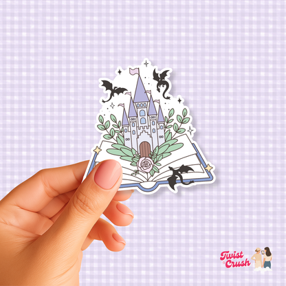 Open-book dragon sticker showing a book, two black dragons, and floral accents