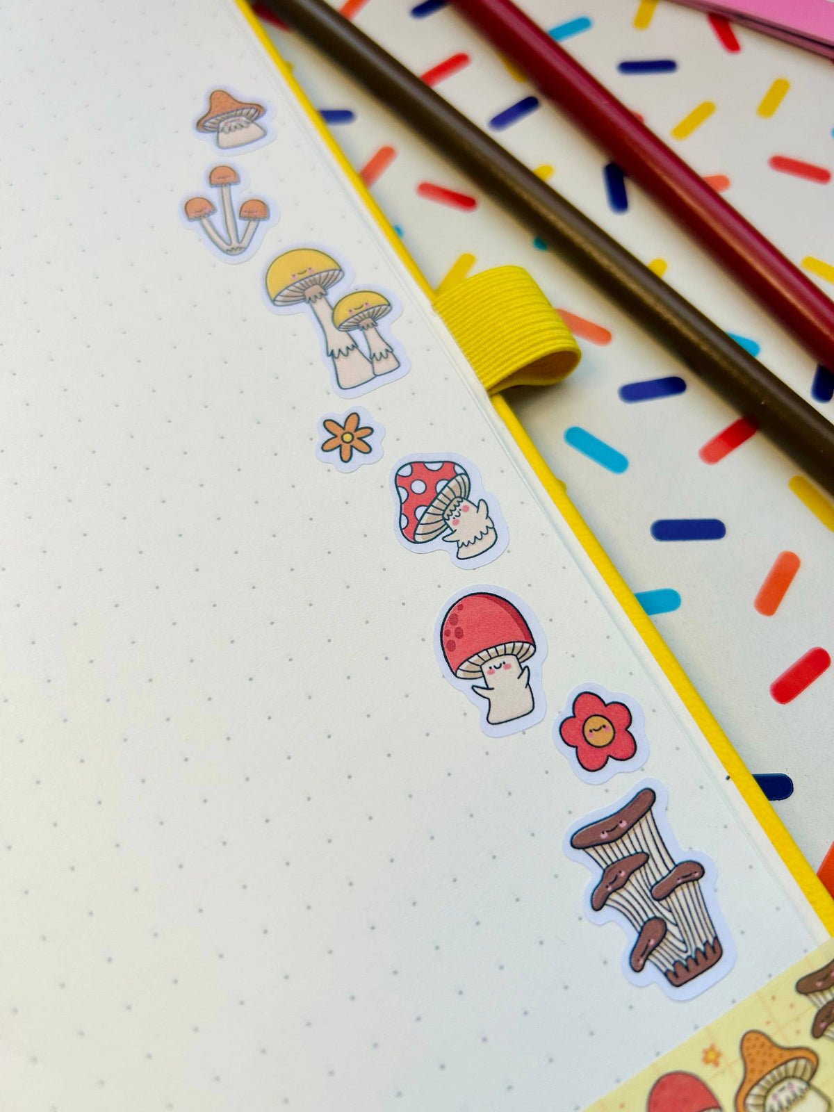 Sticker sheet section with yellow-capped mushrooms, pink flowers, and red toadstools