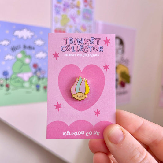 Mini troll head enamel pin, yellow hair and green cap, on pink card
