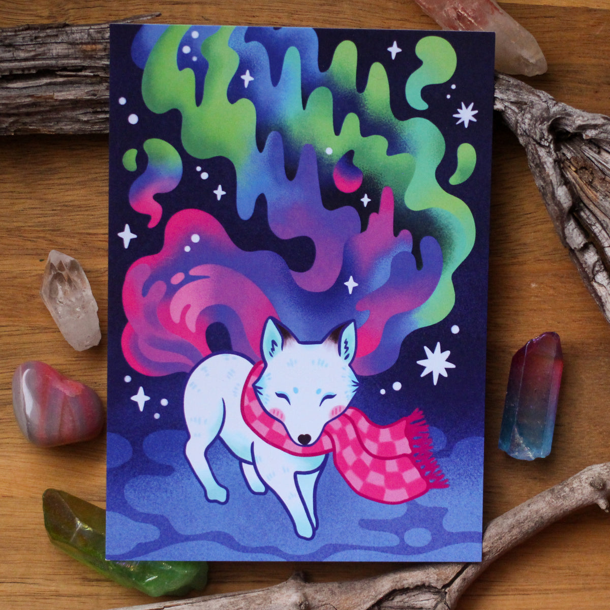 Northern Lights postcard with fox and aurora illustration, blue stars and pink scarf