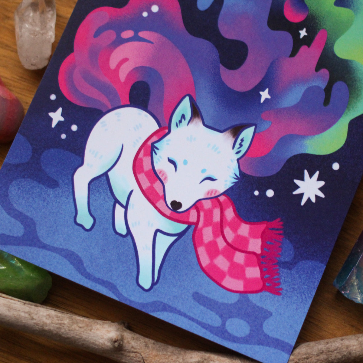 Aurora postcard close-up of a white fox with red scarf against starry night