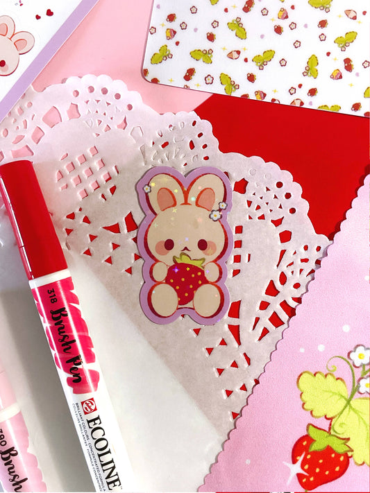 Die-cut holographic sticker sheet with bear holding a strawberry, scalloped lace edge