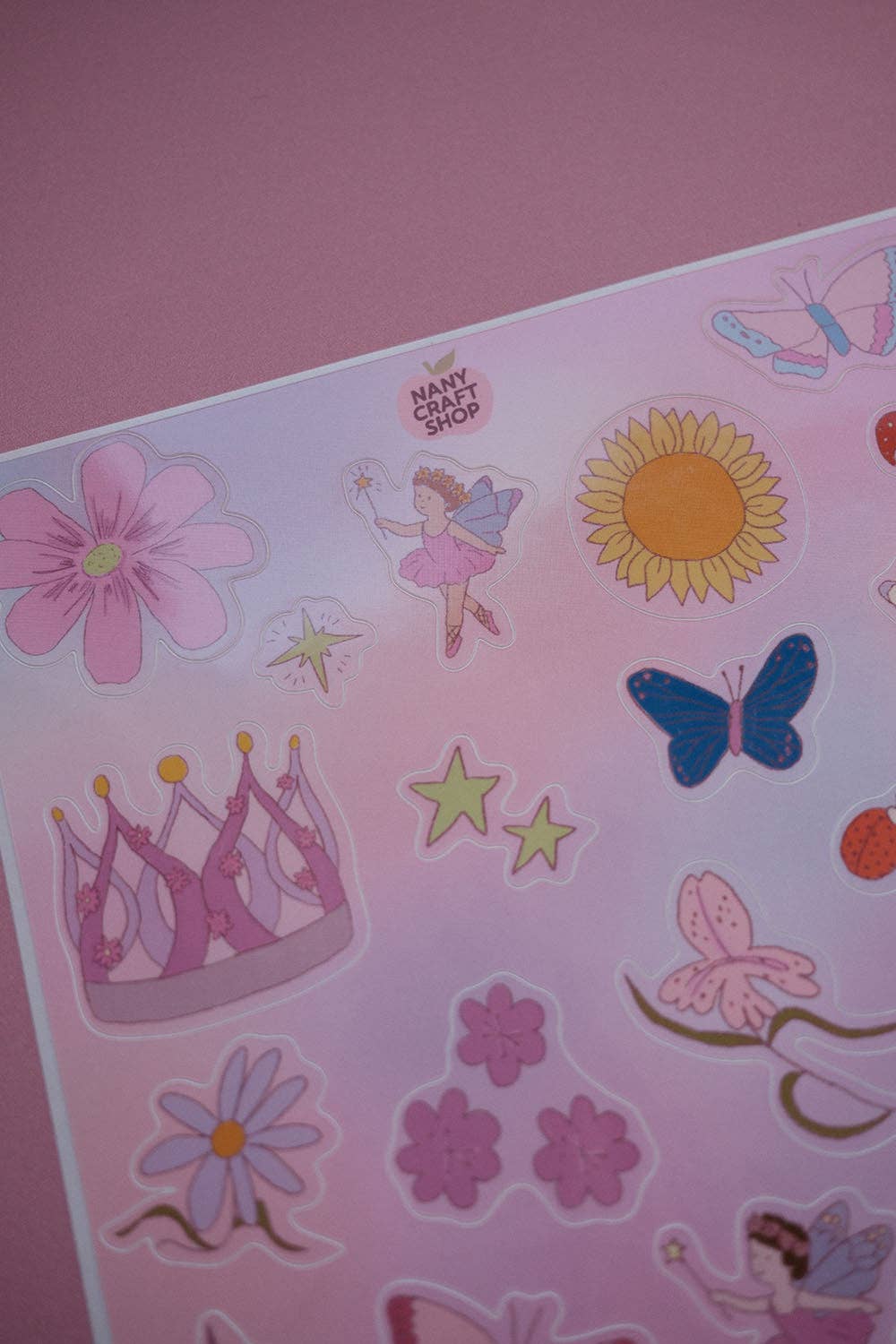 Close-up of fairy sticker sheet showing flower, fairy, butterfly, stars, and mushrooms